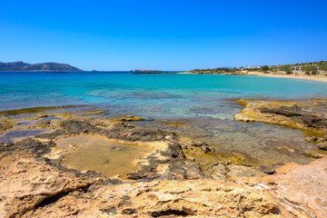 Ano Koufonisi beach with rocks and azure sea water. Small Cyclades, Greece