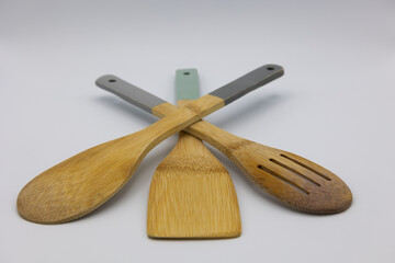 View of three kitchen spoons on a light background.