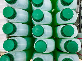 A fascinating collection of a variety of green and white bottles has been meticulously stacked one...
