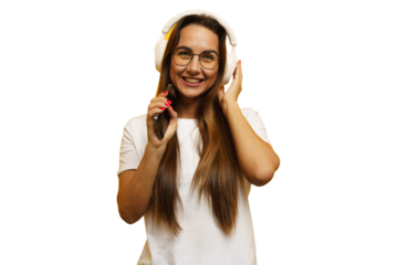 Young woman enjoying music while wearing headphones and smiling in a bright setting