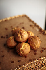Muffin with raisins as small cake home made on wooden table