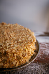 A close-up of a sumptuous Napoleon cake with multiple flaky layers filled with rich cream