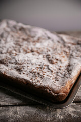 delicious crumble cheesecake from the tin with powder sugar texturetop view