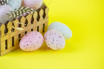 Colored Easter Eggs in Basket on Yellow Background, Happy Easter