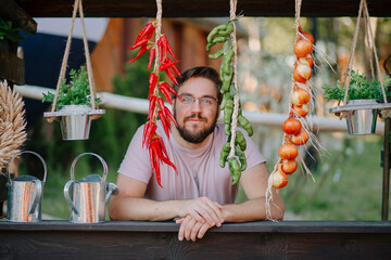 Man sells vegetables at a stall, vegetarian diet, smiling seller, market