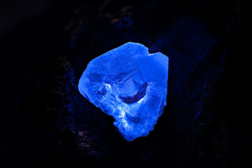 Benitoite blue crystal under longwave UV. Specimen from Gem mine, San Benito Co., California, USA....