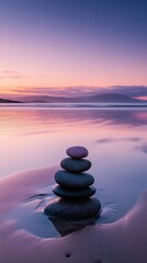 Balanced stones on serene beach at sunset, reflecting vibrant colors in calm water, creating a peaceful and tranquil atmosphere