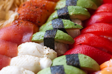Sushi pieces arranged in nice pattern.