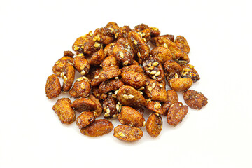 Pile of sweet caramelized peanuts with sesame isolated on white background