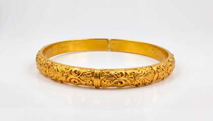 Intricately carved gold bangle on clean white background, elegance