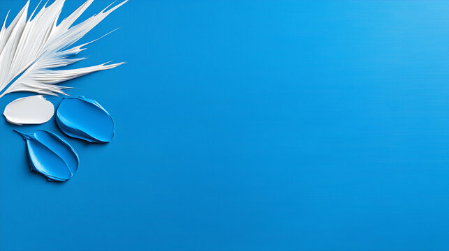 Blue background with a white feather and two blue blobs of paint. Minimalistic background.