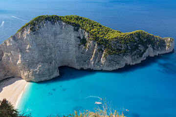 Beautiful Smugglers Cove on the island of Zakynthos captured from an elevated viewpoint on a sunny day