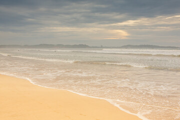 Surfing Paradise and golden beach in Weligama coast of Indian ocean in Sri Lanka. A favorite destination for travelers seeking relaxing, swimming, and enjoying the tropical vibe.