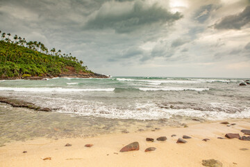 Surfing Paradise and golden beach in Weligama coast of Indian ocean in Sri Lanka. A favorite destination for travelers seeking relaxing, swimming, and enjoying the tropical vibe.