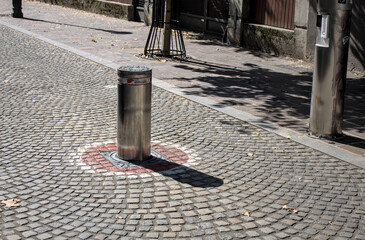 Retractable pole or automatic bollard to stop traffic in the pedestrian downtown district of...