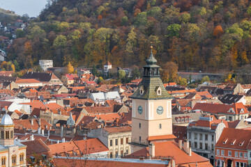 Fototapeta premium Zoom on the tower of the Council's House, Casa Sfatului on thePiata Sfatului council square in Brasov, Transylvania, Romania. Beautiful famous must-see tourist attraction. Travel destination