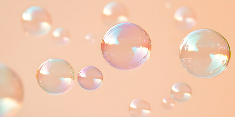 Fototapeta premium Floating iridescent soap bubbles against a soft peach background. A dreamy, ethereal image perfect for backgrounds or product displays.