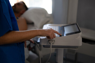 nurses performing electrocardiogram on a patient in ICU