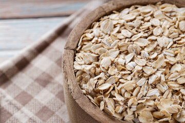 Raw Rolled Oats in Wooden Bowl, Healthy Eating Concept, Copy Space