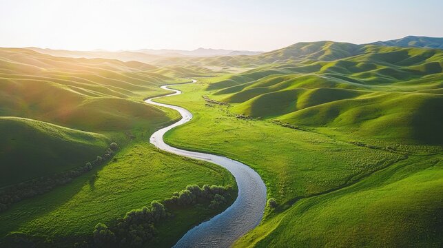 A river runs through a lush green valley