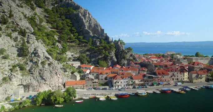 Aerial drone view of the coastal Mediterranean town of Omis in the south of Croatia. Famous tourist summer resort by Adriatic Sea.
