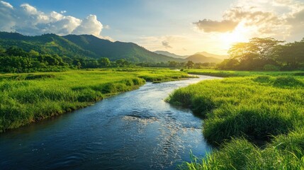 Obraz premium A river with a green grassy bank and mountains in the background