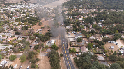 Ojai, California, USA, Sunday January 26th, 2025. Electric Car Fire amidst the Pacific Palisades, Eaton Fire Wildfire event. Police and fire department are in attendance Aerial Drone view
