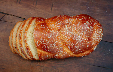 Easter sweet bread, homemade tsoureki braid on wooden table, top view