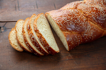 Easter sweet bread, homemade tsoureki braid on wooden table, closeup