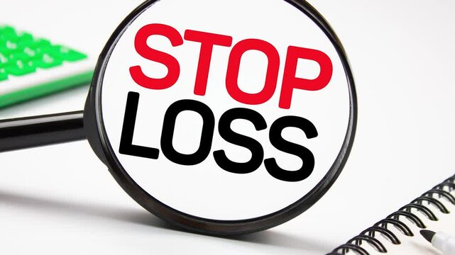 STOP LOSS text, word through a magnifying glass with a calculator on the table. Stop loss business concept, animation.