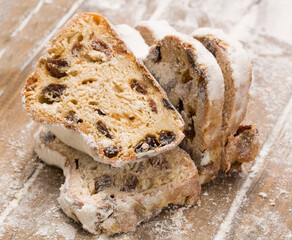 sliced ​​german stollen cake on wooden background