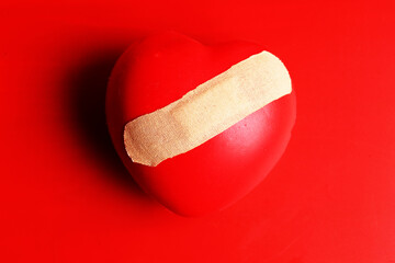 heart figurine with bandage. Broken heart concept