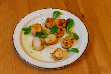 Delicious fried scallops on a table