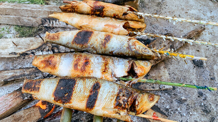 Grilled milkfish over charcoal.