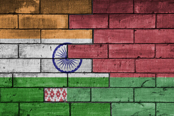 colourful painted big flag of india and flag of belarus on a massive old brick wall background. concept