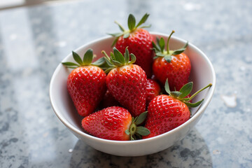 Fresh strawberries on marble countertop with water droplets