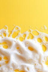 vertical image close-up white soap foam and bubbles on bright yellow background top view with copy space