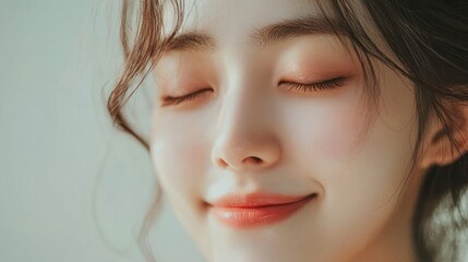 A softly smiling Korean woman with clean natural skin against a light background. Her fresh look highlights the essence of a skincare concept emphasizing beauty without makeup