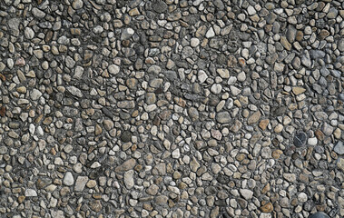 A close-up view of various-sized pebbles creating a textured surface.