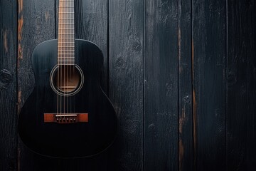 Fototapeta premium Elegant Black Acoustic Guitar Resting on a Deep Brown Wooden Surface