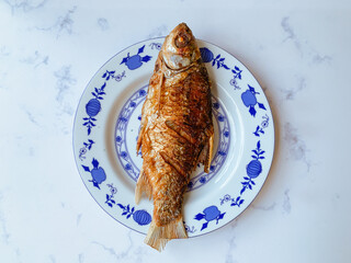 Fried Kendia fish or Thynnichthys on a plate