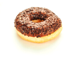 A chocolate donut with sprinkles on top. The donut is sitting on a white background. Internationally popular pastry product and snack.