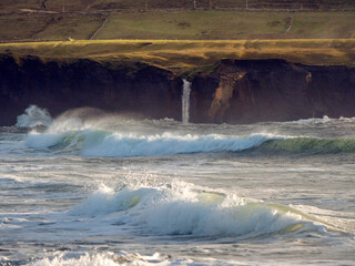 Powerful ocean waves and rough rocky coastline. Dramatic nature scene in Doolin, Ireland. Popular travel area with amazing scenery. Travel and tourism location.