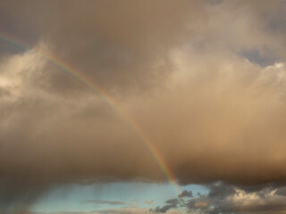 Rainy cloud with rainbow. Nature abstract background.