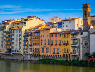 Florence, Italy. Arno river and panoramic view of Firenze old town with old building on a shore on a sunny day