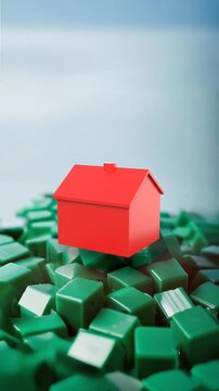 Vertical looping Housing market monopoly concept: red house spinning above green houses