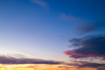 Fototapeta premium Evening sunset sky with clouds painted in bright colors. Sunset landscape, sky background