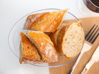 Sliced loaves of freshly baked french bread baguette on table