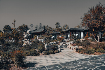 Traditional Chinese Pavilion Surrounded by Autumn Foliage in a Garden