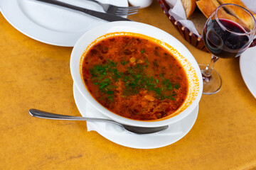 Georgian traditional cuisine, soup kharcho on a white ceramic plate